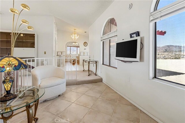 6333 Carodean Rd Unit 29, Palms, CA 92277 - living area featuring light tile patterned floors, a chandelier, and high vaulted ceiling
