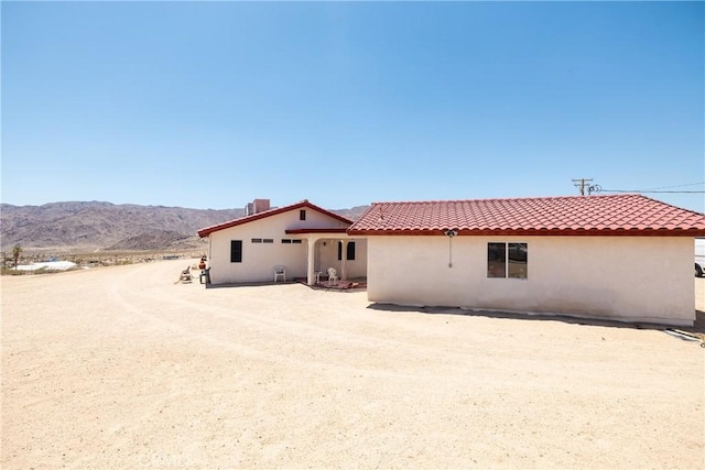 6333 Carodean Rd Unit 29, Palms, CA 92277 - rear view of house featuring stucco siding, a mountain view, and a tiled roof