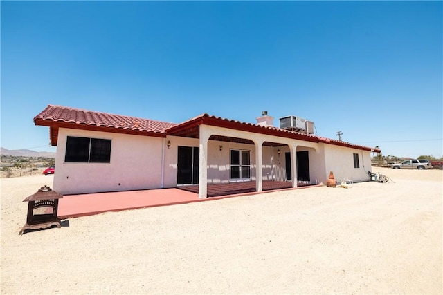 6333 Carodean Rd Unit 29, Palms, CA 92277 - rear view of house with a patio, a tile roof, and stucco siding