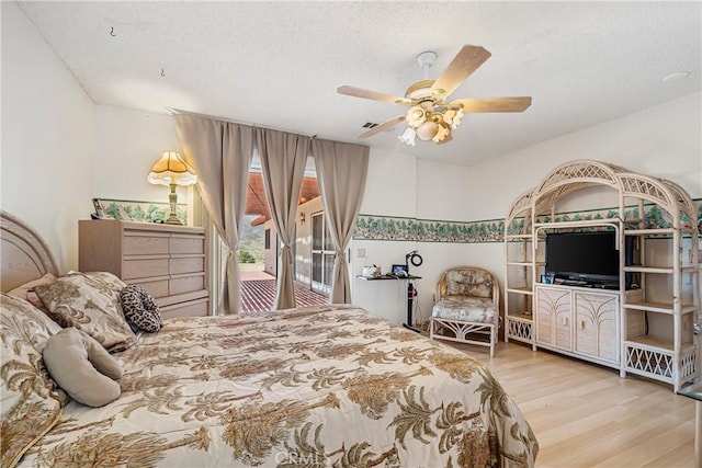 6333 Carodean Rd Unit 29, Palms, CA 92277 - bedroom with wood finished floors, a textured ceiling, and ceiling fan