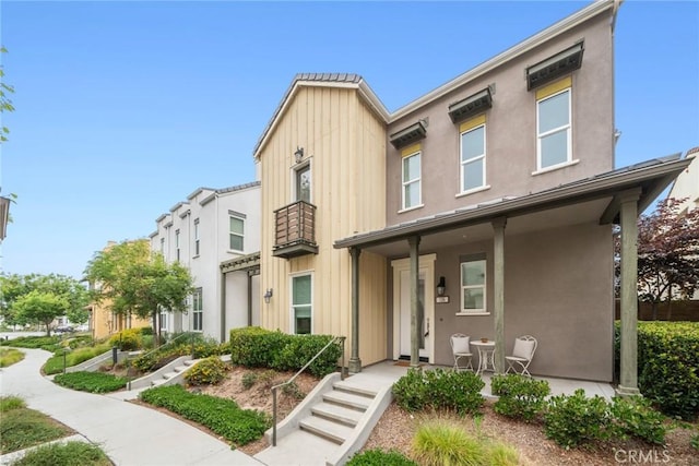 135 Acamar, Irvine, CA 92618 - view of property featuring a porch, board and batten siding, and stucco siding