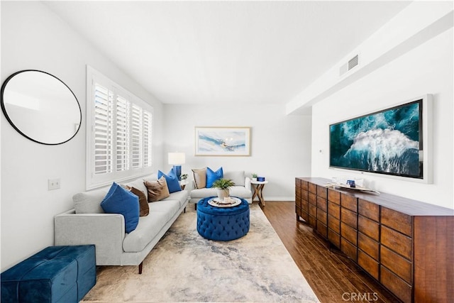67 Remington Unit 231, Irvine, CA 92620 - living area featuring dark wood-style floors and baseboards