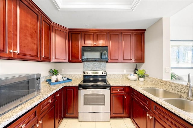 67 Remington Unit 231, Irvine, CA 92620 - kitchen with stainless steel appliances, dark brown cabinets, light stone countertops, and light tile patterned floors