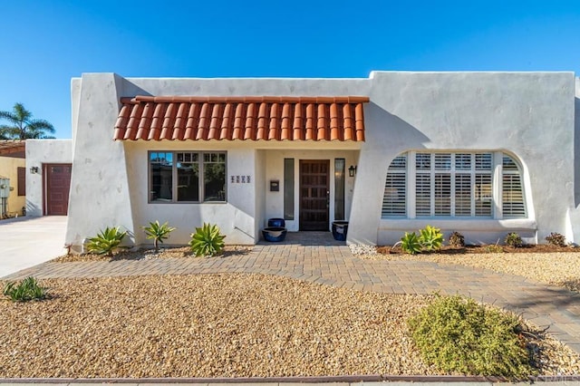 4280 Trias St, San Diego, CA 92103 - view of front facade featuring an attached garage, driveway, stucco siding, and a tile roof