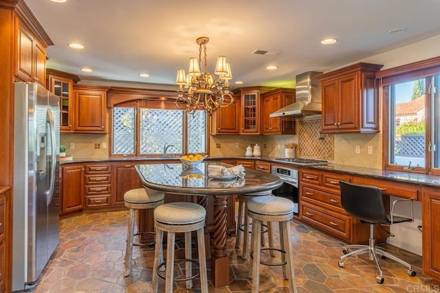 4280 Trias St, San Diego, CA 92103 - kitchen with wall chimney exhaust hood, stainless steel appliances, brown cabinets, a chandelier, and recessed lighting
