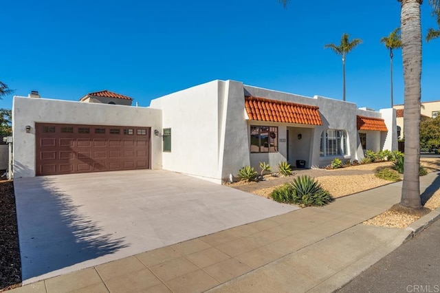 4280 Trias St, San Diego, CA 92103 - pueblo revival-style home with driveway, stucco siding, a tile roof, and a garage