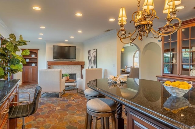 4280 Trias St, San Diego, CA 92103 - dining room with recessed lighting, ornamental molding, arched walkways, dark stone finish floors, and a fireplace