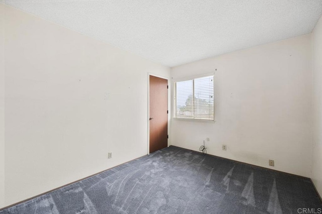 1113 Camino Del Sol Cir, Carlsbad, CA 92008 - spare room featuring dark colored carpet and a textured ceiling