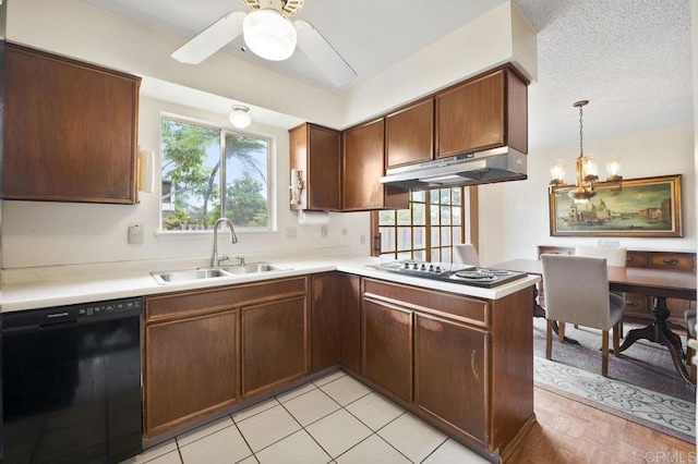 1113 Camino Del Sol Cir, Carlsbad, CA 92008 - kitchen with dishwasher, under cabinet range hood, light countertops, ceiling fan, and a peninsula