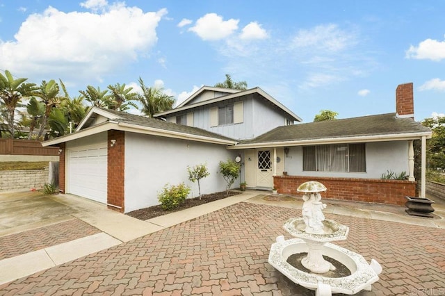 1113 Camino Del Sol Cir, Carlsbad, CA 92008 - tri-level home with concrete driveway, a chimney, a garage, stucco siding, and brick siding