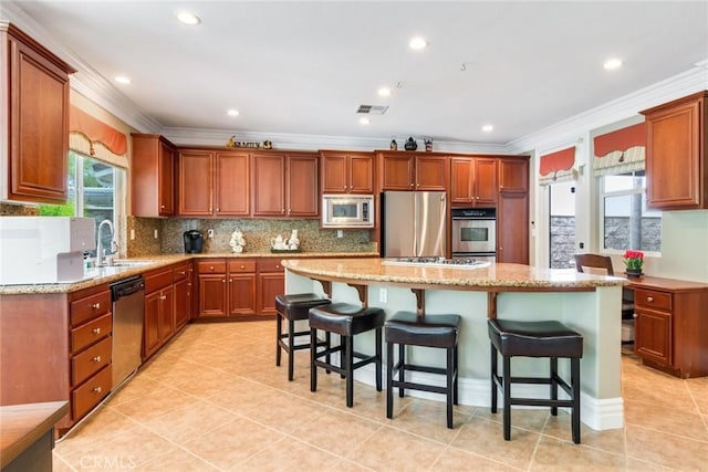 3820 Bidwell Dr, Yorba Linda, CA 92886 - kitchen featuring appliances with stainless steel finishes, ornamental molding, a center island, a breakfast bar, and light tile patterned floors