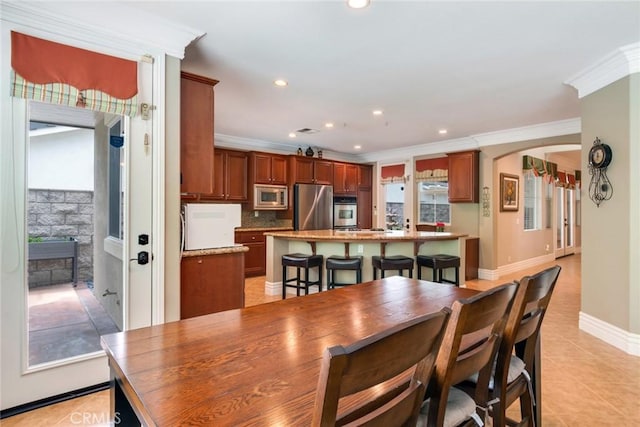 3820 Bidwell Dr, Yorba Linda, CA 92886 - dining space featuring crown molding, recessed lighting, light tile patterned flooring, and arched walkways