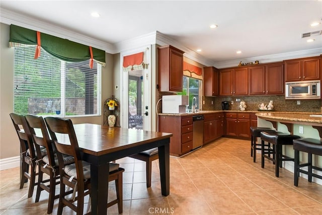 3820 Bidwell Dr, Yorba Linda, CA 92886 - kitchen with appliances with stainless steel finishes, crown molding, backsplash, light tile patterned floors, and recessed lighting