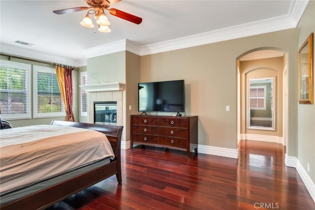 3820 Bidwell Dr, Yorba Linda, CA 92886 - bedroom with wood finished floors, crown molding, arched walkways, a tile fireplace, and ceiling fan