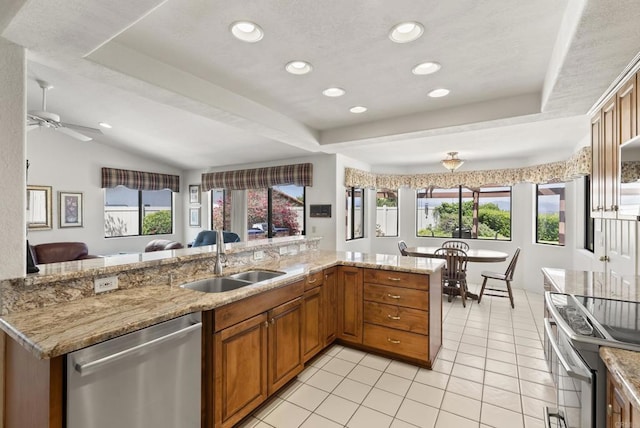2221 Cortina Cir, Escondido, CA 92029 - kitchen with stainless steel appliances, open floor plan, brown cabinets, light tile patterned flooring, and a ceiling fan