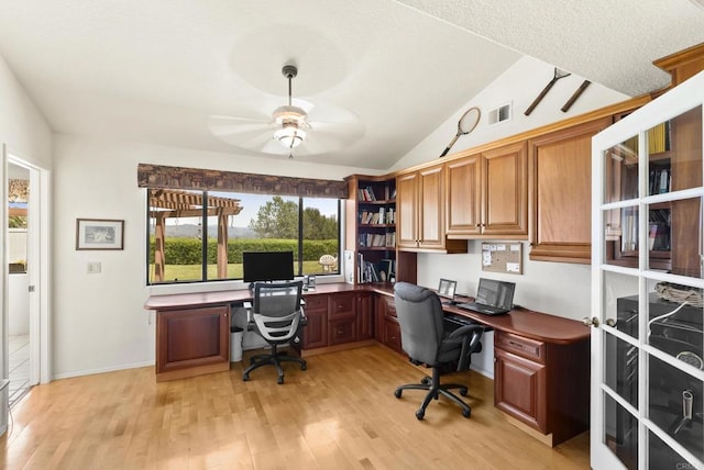 2221 Cortina Cir, Escondido, CA 92029 - home office with vaulted ceiling, ceiling fan, light wood-style floors, and built in desk