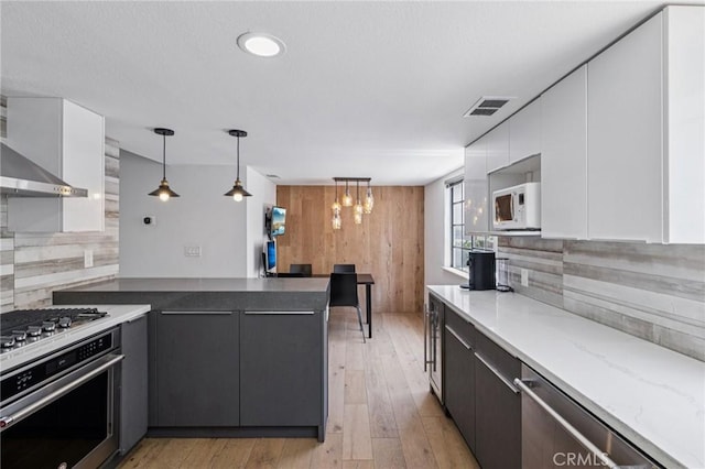 434 S Los Robles Ave Unit 4, Pasadena, CA 91101 - kitchen with appliances with stainless steel finishes, white cabinetry, a peninsula, light wood-type flooring, and pendant lighting