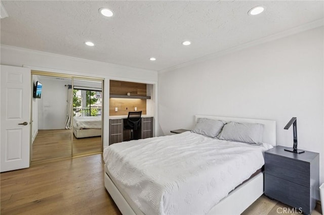 434 S Los Robles Ave Unit 4, Pasadena, CA 91101 - bedroom with crown molding, wood finished floors, a textured ceiling, and recessed lighting
