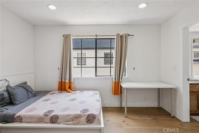 434 S Los Robles Ave Unit 4, Pasadena, CA 91101 - bedroom featuring wood finished floors, multiple windows, a textured ceiling, and recessed lighting
