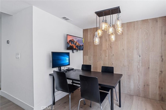 434 S Los Robles Ave Unit 4, Pasadena, CA 91101 - dining space featuring wooden walls, wood finished floors, and a chandelier
