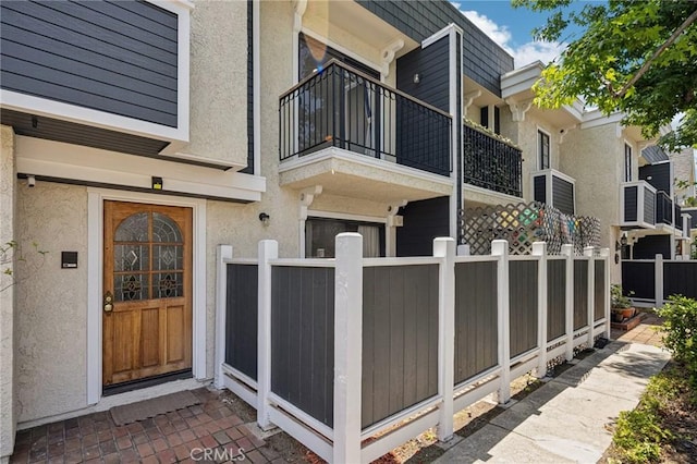 434 S Los Robles Ave Unit 4, Pasadena, CA 91101 - view of exterior entry featuring a balcony and stucco siding