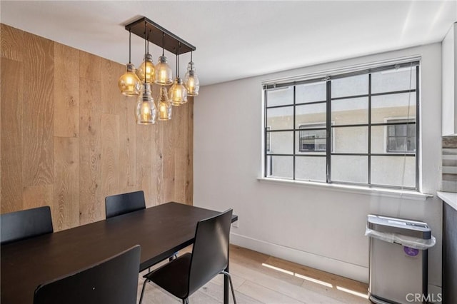 434 S Los Robles Ave Unit 4, Pasadena, CA 91101 - dining room featuring plenty of natural light, a chandelier, wood walls, and light wood-type flooring