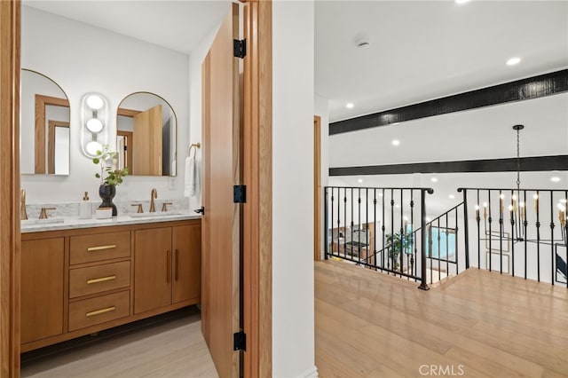 4016 Old Topanga Canyon Rd, Calabasas, CA 91302 - full bath with a chandelier, wood finished floors, double vanity, beam ceiling, and recessed lighting