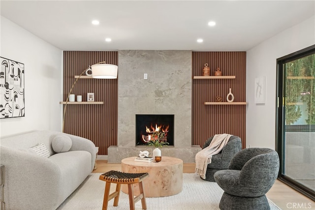 4016 Old Topanga Canyon Rd, Calabasas, CA 91302 - living room featuring recessed lighting, a premium fireplace, wood finished floors, and an accent wall
