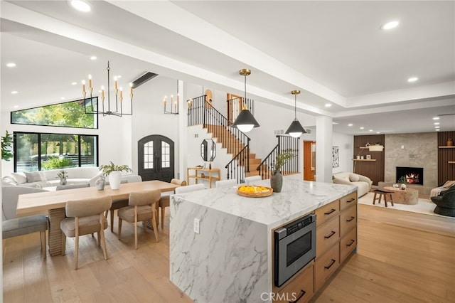 4016 Old Topanga Canyon Rd, Calabasas, CA 91302 - kitchen featuring open floor plan, stainless steel microwave, french doors, a high end fireplace, and recessed lighting