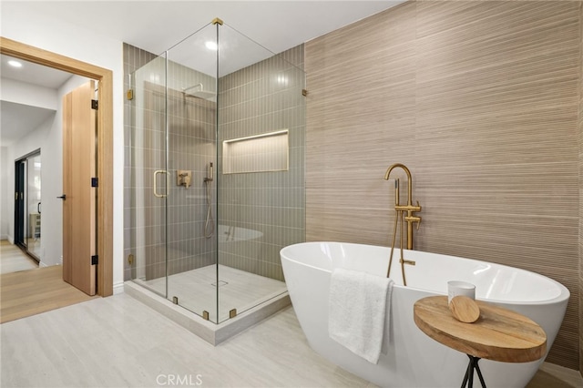 4016 Old Topanga Canyon Rd, Calabasas, CA 91302 - bathroom featuring a stall shower, a soaking tub, tile walls, wood finished floors, and recessed lighting