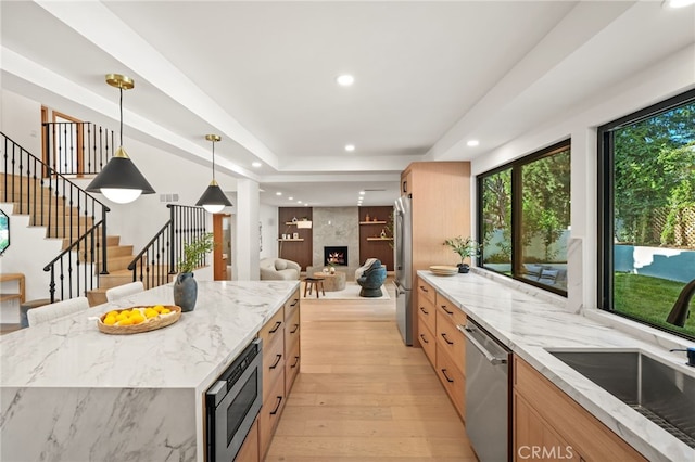 4016 Old Topanga Canyon Rd, Calabasas, CA 91302 - kitchen featuring stainless steel appliances, light wood finished floors, light brown cabinetry, light stone counters, and recessed lighting