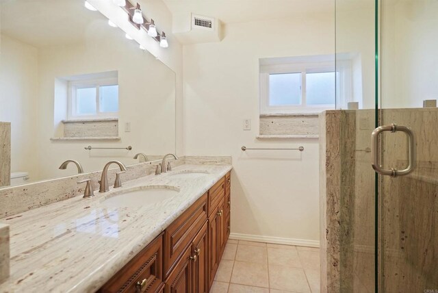 5884 Redondo Dr, Bonsall, CA 92003 - bathroom with double vanity, healthy amount of natural light, tile patterned floors, and a shower stall