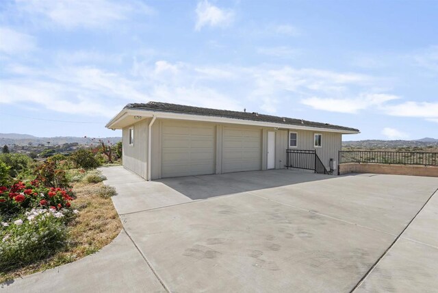5884 Redondo Dr, Bonsall, CA 92003 - view of front of house with a detached garage and a mountain view