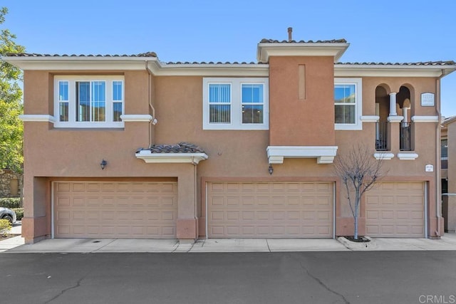 12737 Savannah Creek Dr Unit 280, San Diego, CA 92128 - view of front facade featuring a garage and stucco siding