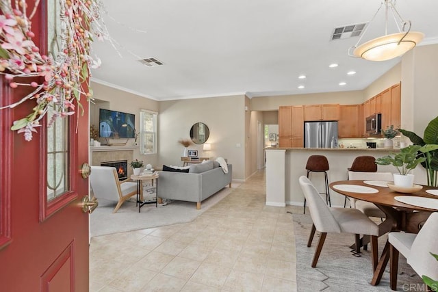 12737 Savannah Creek Dr Unit 280, San Diego, CA 92128 - dining space featuring a glass covered fireplace, ornamental molding, light tile patterned flooring, and recessed lighting