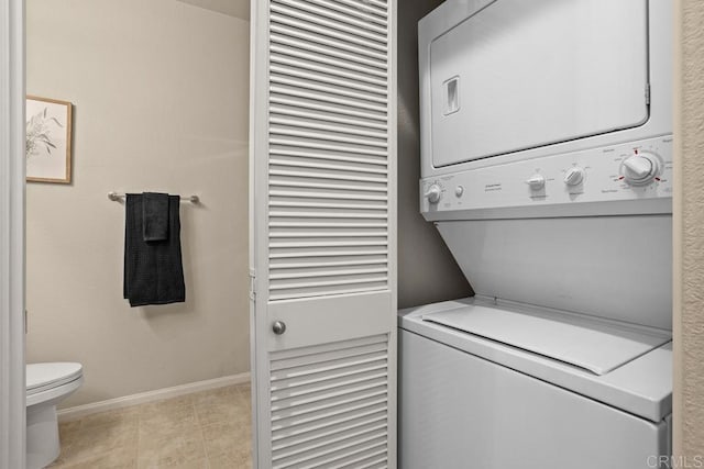 12737 Savannah Creek Dr Unit 280, San Diego, CA 92128 - laundry room featuring stacked washer / dryer and baseboards