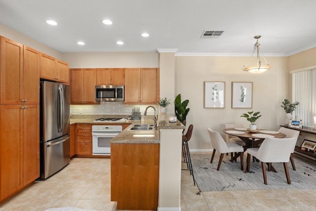 12737 Savannah Creek Dr Unit 280, San Diego, CA 92128 - kitchen with appliances with stainless steel finishes, a peninsula, light tile patterned floors, backsplash, and crown molding