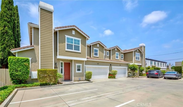 8647 Belmont St, Cypress, CA 90630 - multi unit property featuring a chimney, driveway, stucco siding, and a tile roof