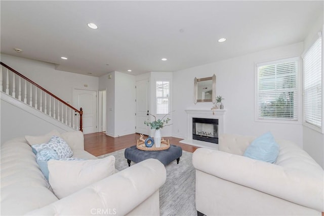8647 Belmont St, Cypress, CA 90630 - living room featuring wood finished floors, stairway, recessed lighting, and a fireplace with raised hearth