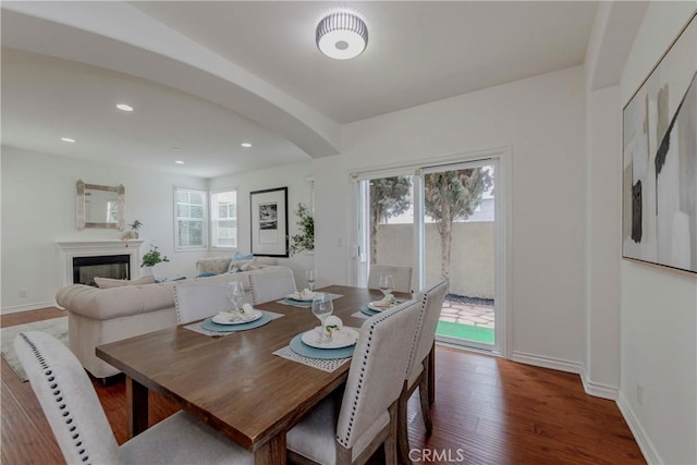 8647 Belmont St, Cypress, CA 90630 - dining area with arched walkways, wood finished floors, recessed lighting, and a glass covered fireplace