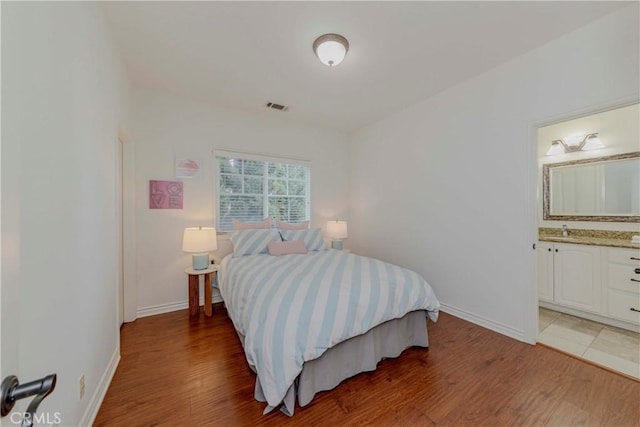 8647 Belmont St, Cypress, CA 90630 - bedroom with light wood-style floors and ensuite bathroom