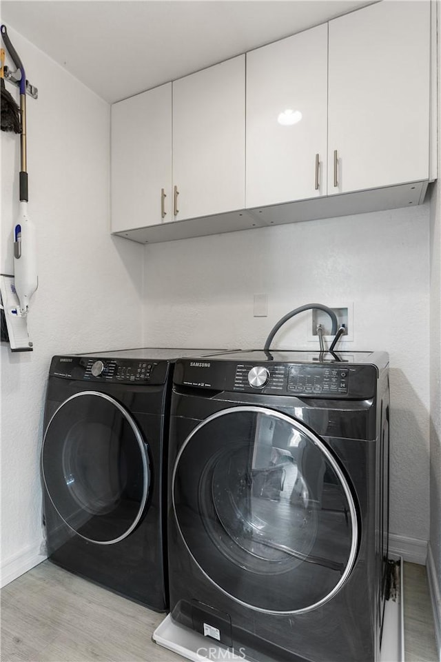 7625 Reseda Blvd Unit 302, Reseda, CA 91335 - laundry area featuring cabinet space, washing machine and clothes dryer, and wood finished floors