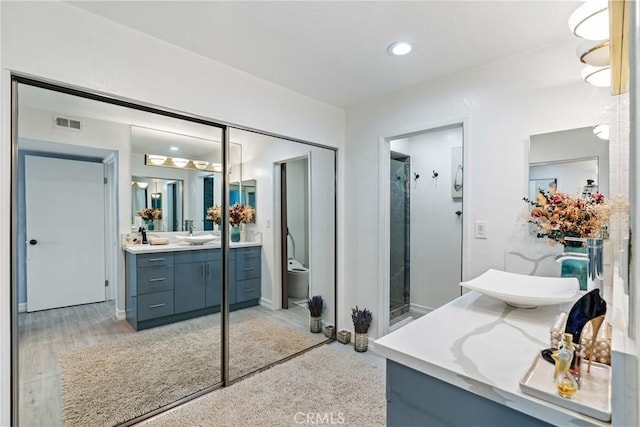 7625 Reseda Blvd Unit 302, Reseda, CA 91335 - full bathroom featuring vanity, wood finished floors, and a shower