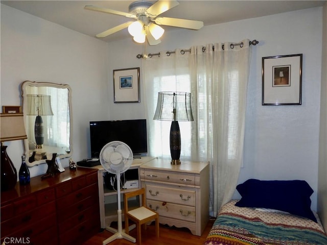 7106 Elmwood Rd, San Bernardino, CA 92404 - bedroom with a desk, wood finished floors, and a ceiling fan
