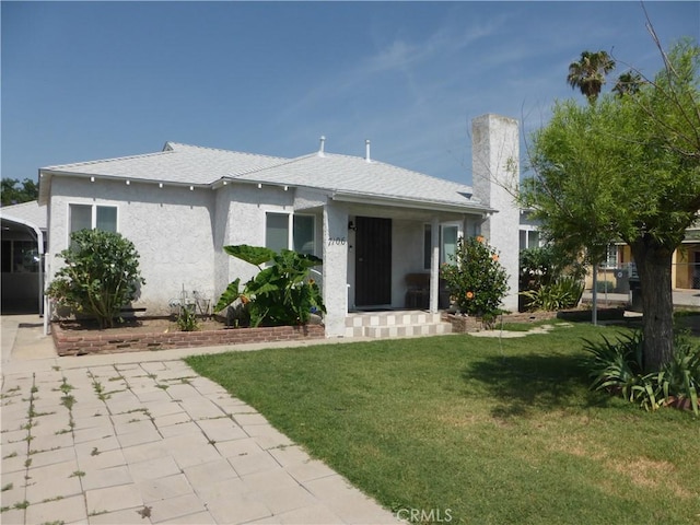 7106 Elmwood Rd, San Bernardino, CA 92404 - bungalow-style house featuring a front lawn, stucco siding, and a shingled roof