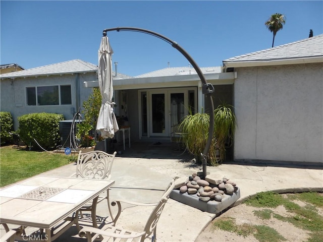 7106 Elmwood Rd, San Bernardino, CA 92404 - back of property featuring a patio, outdoor dining area, and stucco siding