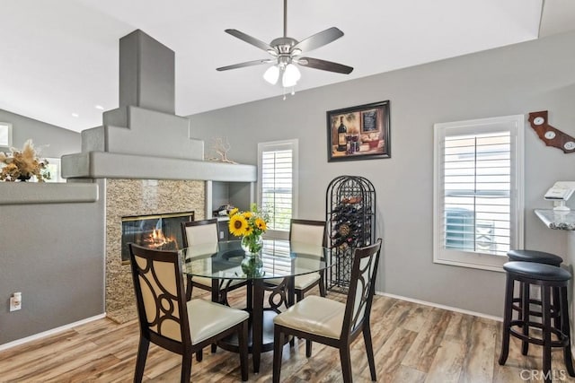 33180 Camino Piedra Rojo, Temecula, CA 92592 - dining room featuring ceiling fan, wood finished floors, a tiled fireplace, and vaulted ceiling
