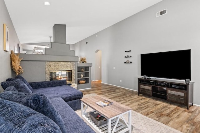33180 Camino Piedra Rojo, Temecula, CA 92592 - living room with wood finished floors, arched walkways, a multi sided fireplace, and recessed lighting