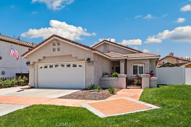 33180 Camino Piedra Rojo, Temecula, CA 92592 - view of front of home with an attached garage, concrete driveway, a gate, stucco siding, and a tiled roof