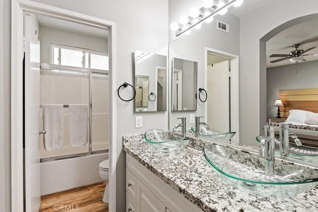 33180 Camino Piedra Rojo, Temecula, CA 92592 - full bath featuring vanity, bath / shower combo with glass door, wood finished floors, and ceiling fan